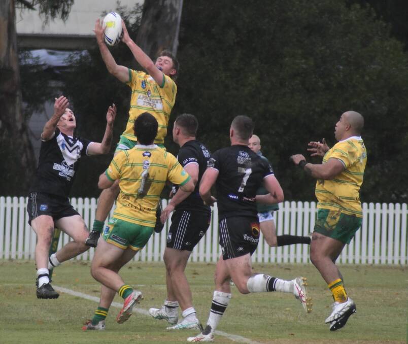 Orange CYMS do battle with Forbes Magpies at a muddy Wade Park. Pictures by Jude Keogh