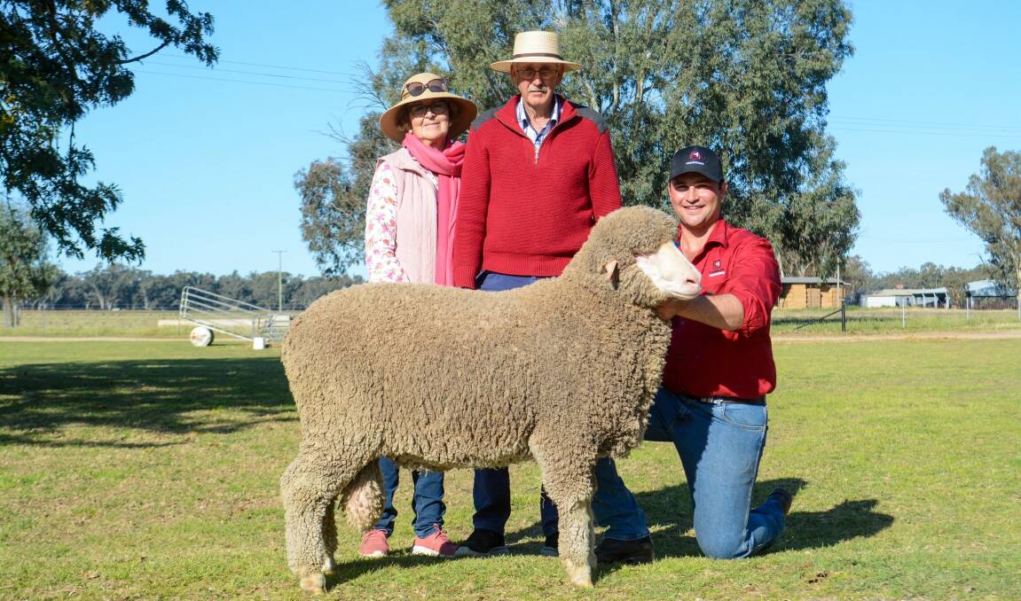 Claudette and Gerald Woodhouse, Myack Poll Merinos, Tarcutta, with Mitch Rubie, Lachlan Merinos, and one of the top-priced rams, which sold for $8500. Picture by Elka Devney