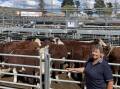 Robyn Reid with her pen of 11, 330-kilogram Kidman-blood Hereford steers which made $980 a head during the recent Monaro weaner sales at Cooma.