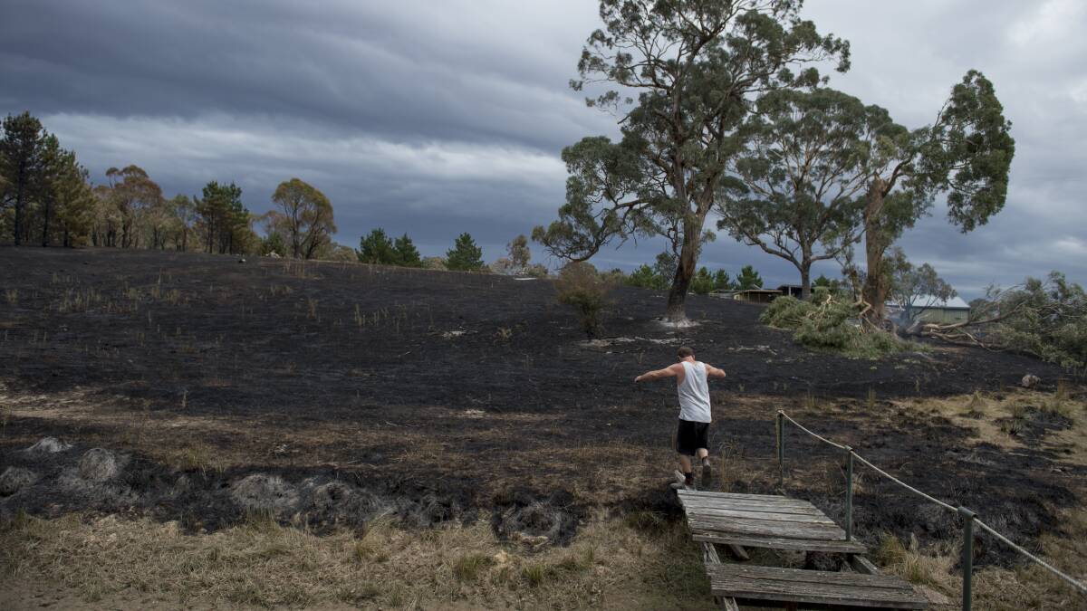 Gerhard Fischer inspects the aftermath of the fast moving grass fire at Widgiewa Rd. Photo: Jay Cronan 