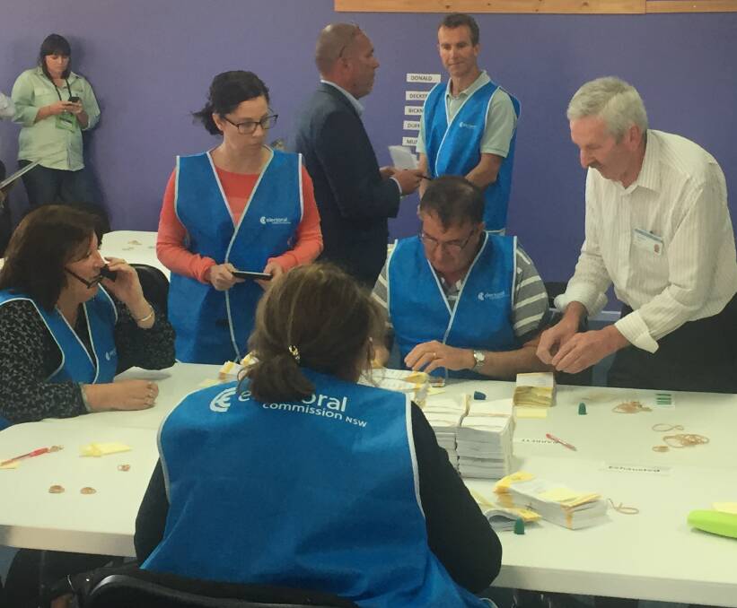 COUNTING ON YOU: NSW Electoral Commission staff working hard at tallying on Thursday. Their numbers will be doubled when the Orange byelection recount commences at 8.30am on Monday. Photo: TONY RHEAD