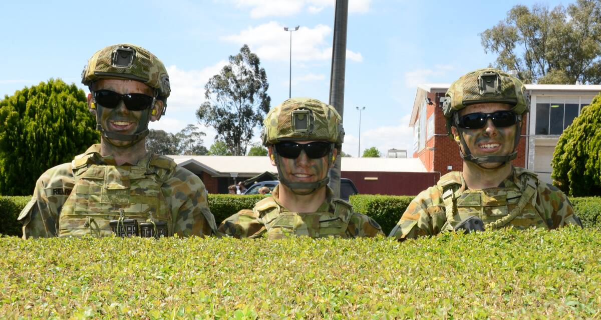All set to go: Dan Reardon, Bryce Meaker and Alex Turner get ready to put on an urban assault display at the Dubbo Army Reserves Depot on Saturday. Photo: PAIGE WILLIAMS