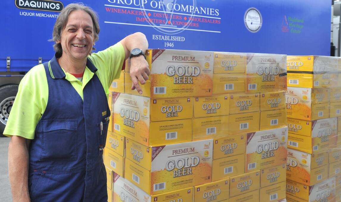 HERE'S CHEERS: Rex D'Aquino with his company's donation of beer to help workers rebuild farm properties near Dunedoo ravaged by bushfires. Photo: JUDE KEOGH 0412jkdaquino1