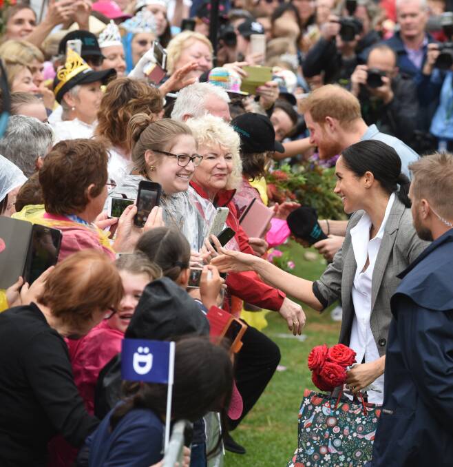 Special moment: The Duke and Duchess of Sussex greet crowds at the Picnic in the Park event at Dubbo. Photo: AMY MCINTYRE