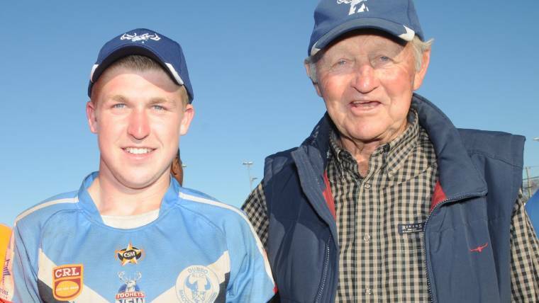 FAMILY: Perry Meredith and his grandfather Barry Perry celebrate Macquarie's win in the 2012 Group 11 grand final.