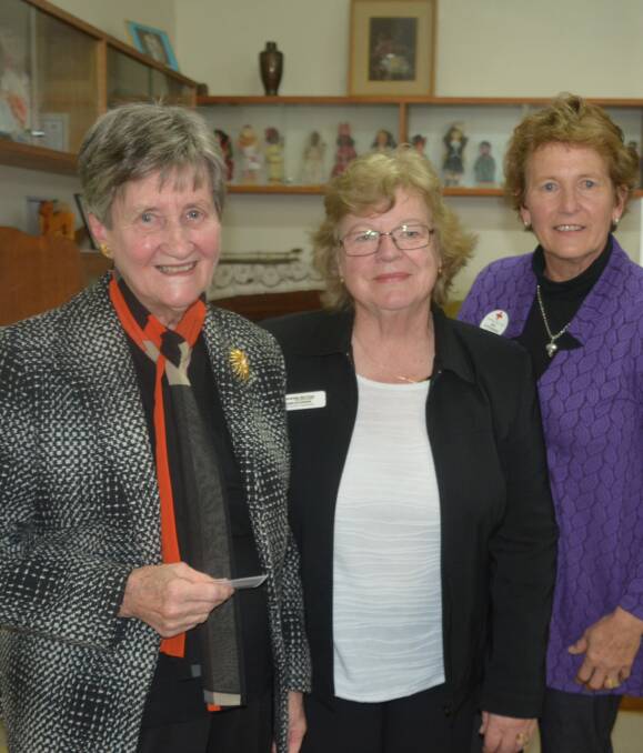 Dedicated : Elaine Pickford receives the gilt rozette from Zone Chairperson Joan Hutchison and Wellington's Bev Hutchinson.