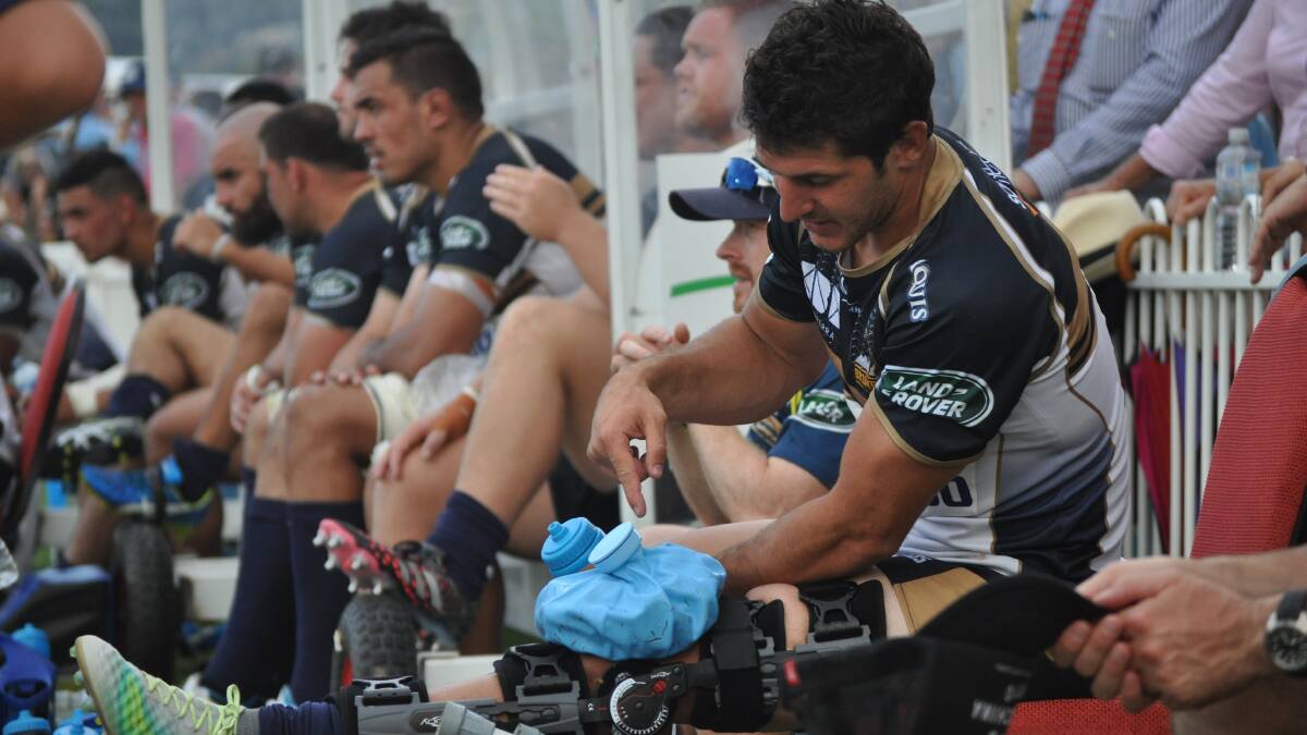 THAT HURTS: ACT halfback Tomas Cubelli sums up what looks to be a pretty serious knee injury. Photo: NICK McGRATH