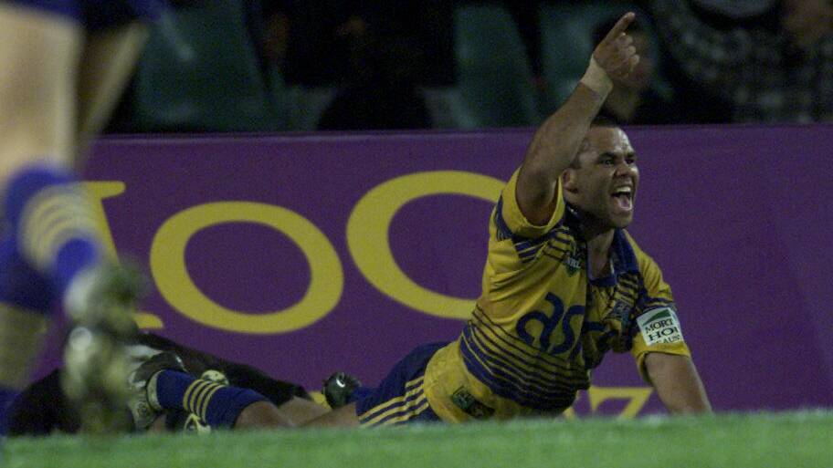 SLIPPERY: Moran celebrates a try with Parramatta in the late 1990s. 