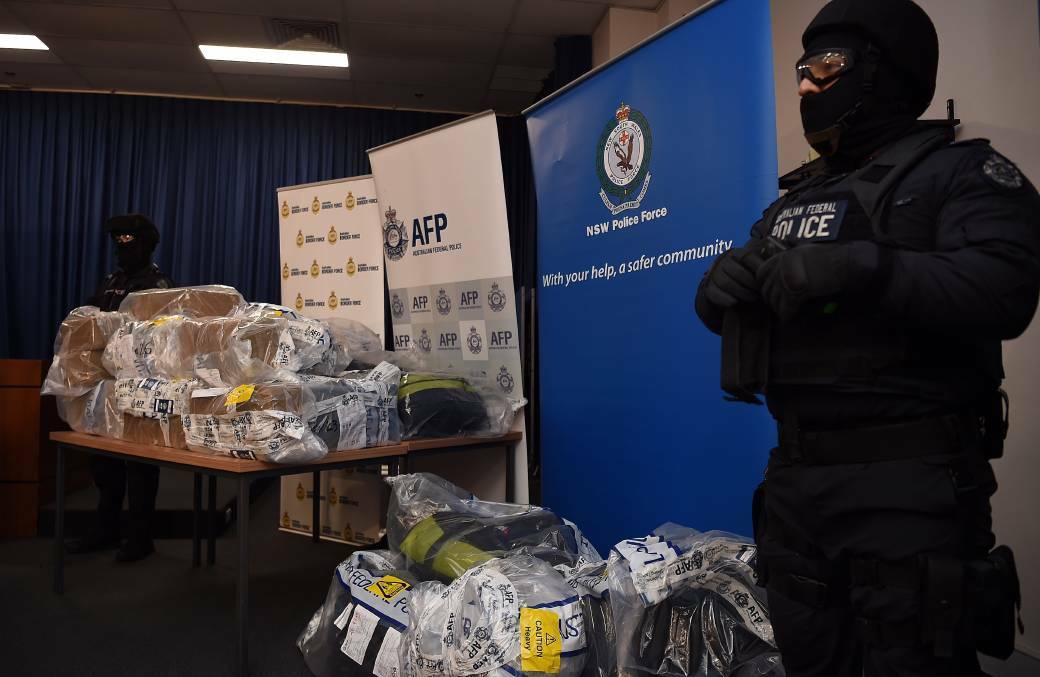 AFP officers stand guard over some of the 500kilo cocaine seized during the Christmas Day bust. Picture: Kate Geraghty
