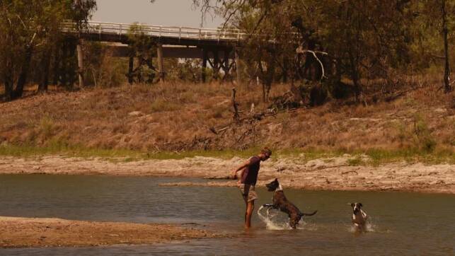 Cooling off amid extreme heat in the Barwon-Darling River near Bourke in January. The town is likely to switch entirely to bore water next month amid record low flows for Australia's longest river. Photo: Kate Geraghty
