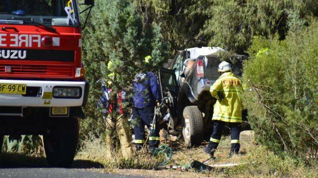 Emergency services examine the wreckage on the Mitchell Highway. Photo: BRIAN HARVEY