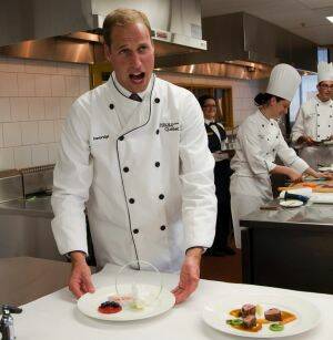 Are there any oysters in this? Prince William tries his hand at cooking during a Royal visit of Canada in 2011. Photo: AP
