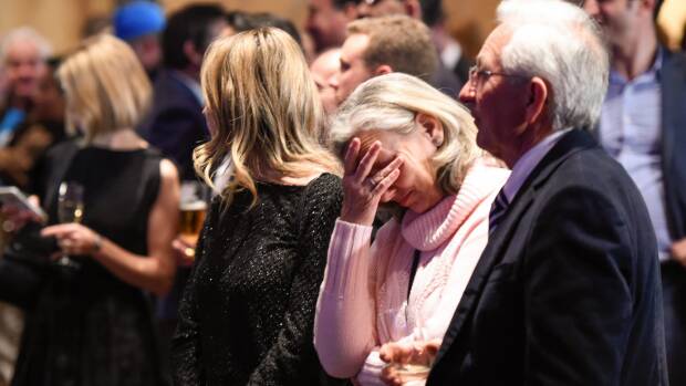 Malcolm Turnbull supporters listen to opposition leader Bill Shorten give his speech on the screen at the Liberal Party election night function. Photo: Wolter Peeters
