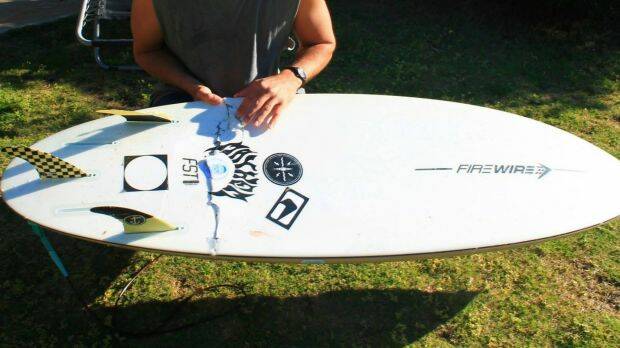 The board was left ripped following Mr Penman's close call with the shark. Photo: Fraser Penman/Facebook
