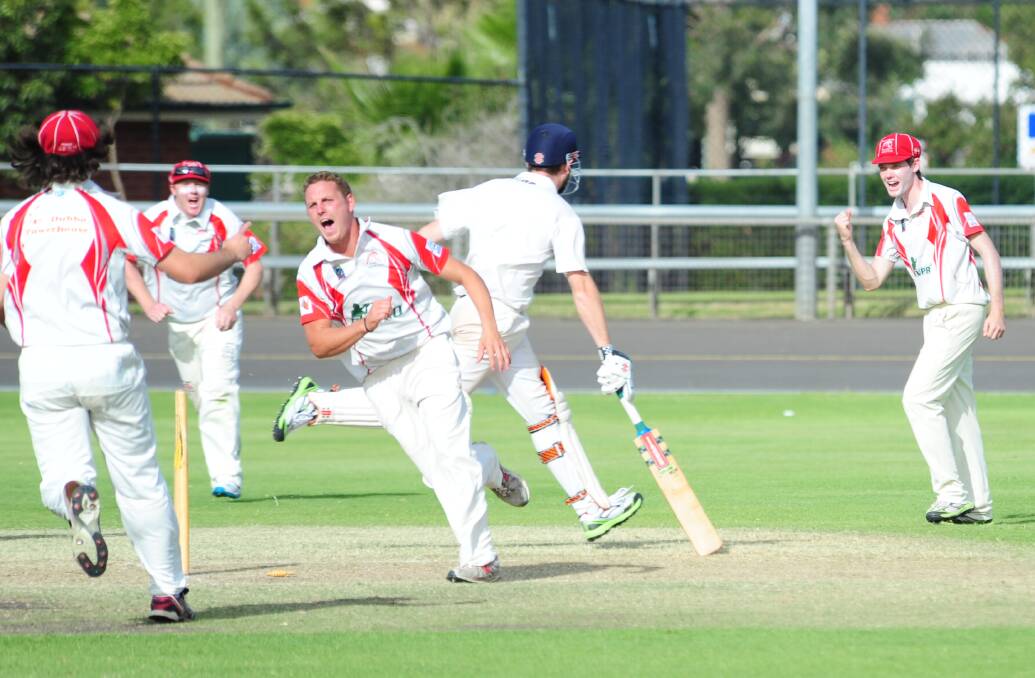 LET THE CELEBRATIONS BEGIN: Greg Buckley wheels away to his teammates after claiming the match-winning run-out.
