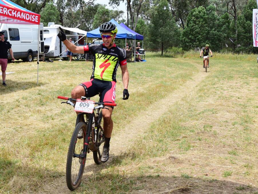 WINNER: Shaun Lewis raises his hand in joy after winning the men's division of the Dubbo 300.