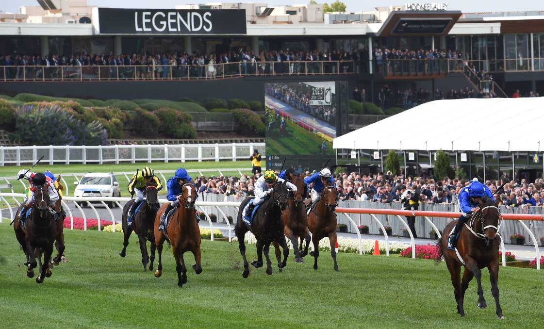 BLINK AND YOU'LL MISS THEM: Winx and Hugh Bowman put a gap on the chasing pack in Saturday's Cox Plate (2040m) at Moonee Valley.