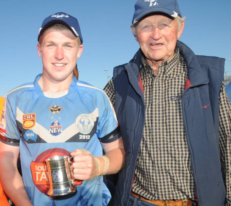 FAMILY: Perry Meredith and his grandfather Barry Perry celebrate Macquarie's win in the 2012 Group 11 grand final.