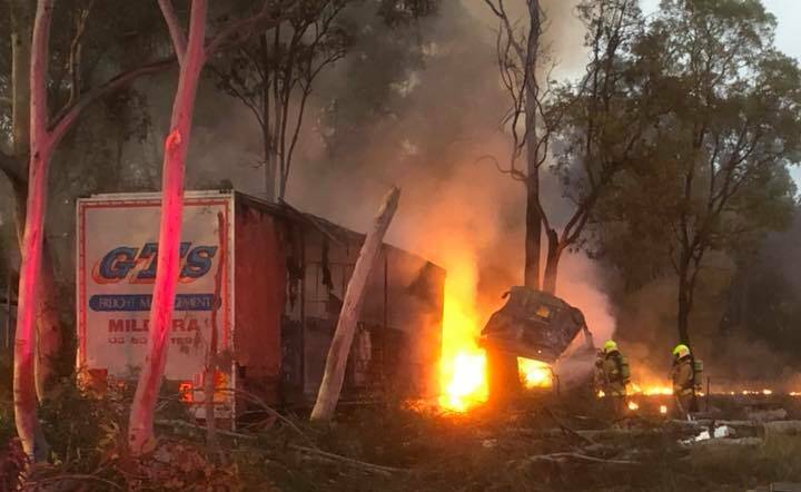 Firefighters attempt to extinguish a blaze after a truck crashed near COonabarabran on Tuesday morning. Photo: COONABRABRAN RESCUE SERVICE