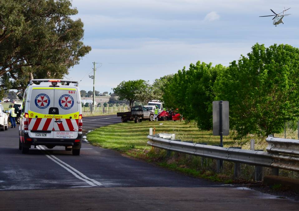 EMERGENCY: A medical helicopter lands at the scene of Saturday's crash on Old Dubbo Road. Photo: BELINDA SOOLE