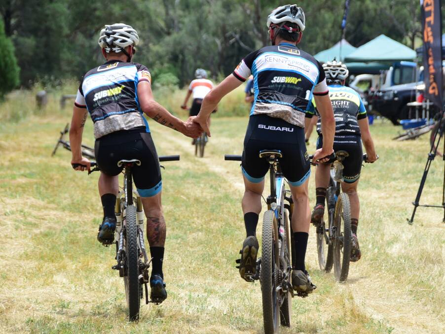 GOOD JOB MATE: Two riders congratulate each other after crossing the line.