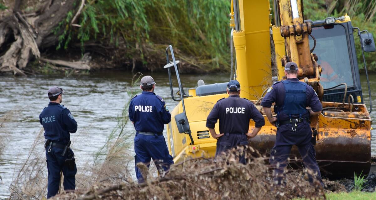 SEARCHING: An excavator digs up part of the riverbank at Butlers Falls on Tuesday. Photo: BELINDA SOOLE