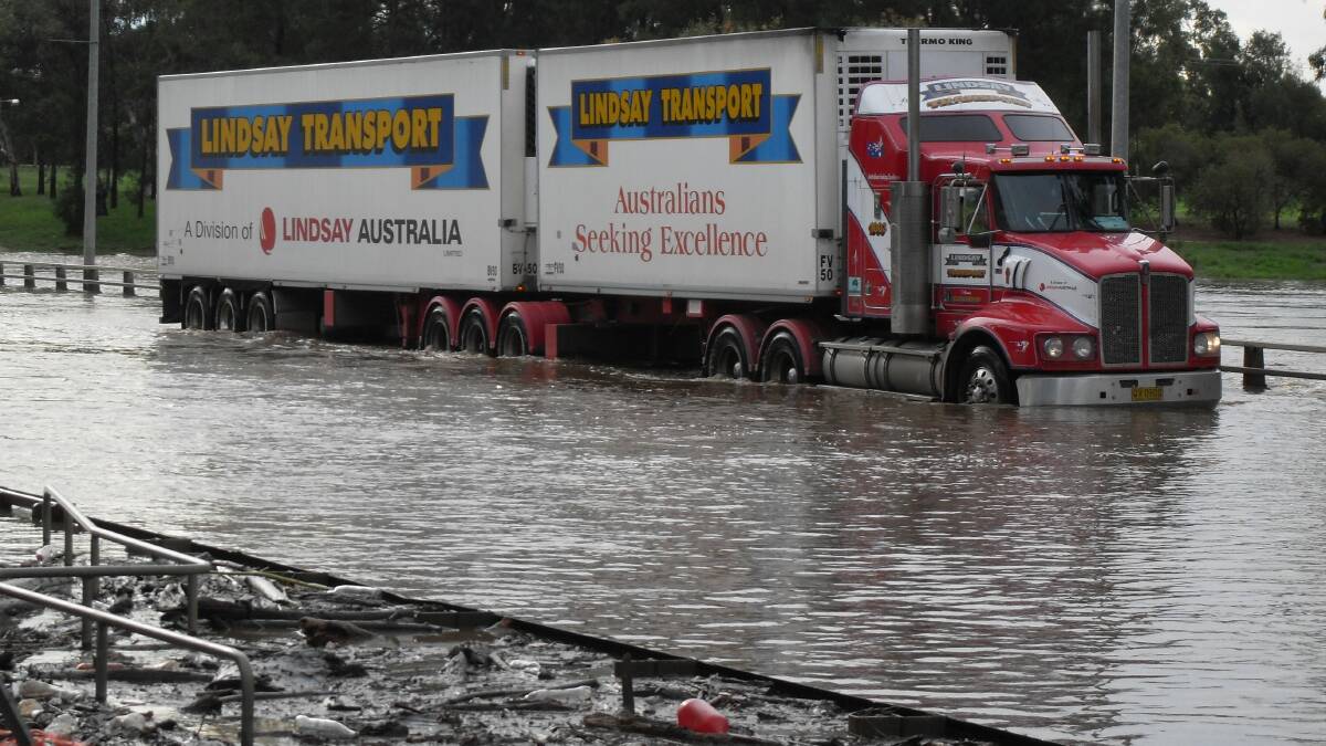 A truck crosses the flooded Emile Serisier Bridge during the 2010 floods.