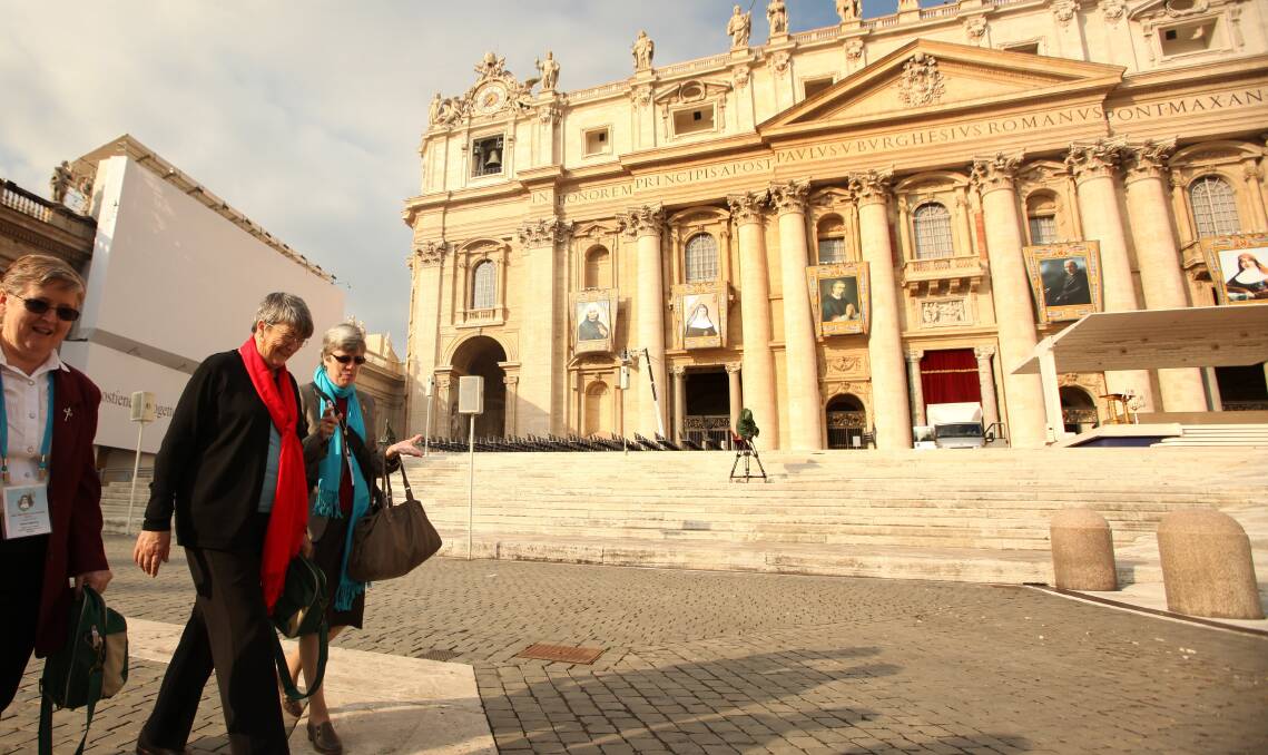 Kathleen Evans, wearing the red scarf, arrives at St Peter's Square ahead of the canonisation service for Mary MacKillop in 2010.