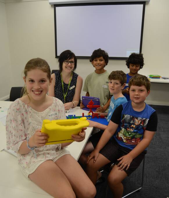 CODING: Matilda Hurst, Zayden and Zamel Berger, and Nathan and Liam Crowley were given a lesson in coding by Dubbo Macquarie Regional Library assistant Sarah Tilbrook on Tuesday afternoon. 