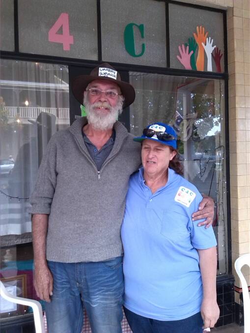 AT WORK: Bronwyn Drew of Caring for Coolah with Paul, a survivor from the village of Uarby. Photo: CONTRIBUTED 