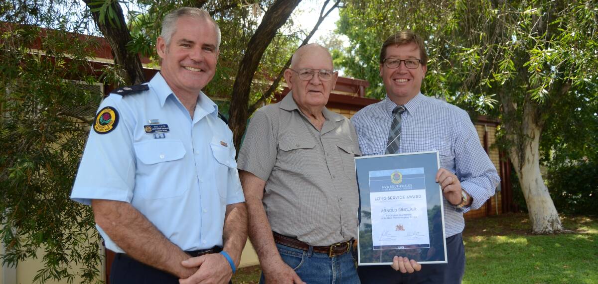 AWARD: NSW SES deputy region controller Phil Lalor, Mr Arnold Sinclair and Minister for Emergency Services Troy Grant. Photo: ELOUISE HAWKEY 