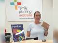 A staff member from Family Planning Australia's Dubbo office with one of the discrete condom and lube packs. Picture supplied