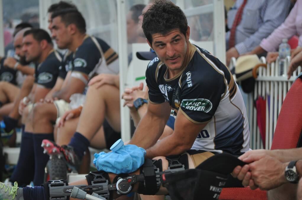 INJURY WORRIES: Brumbies halfback Tomas Cubelli nurses his injured right knee during Saturday's Super Rugby trial match against the NSW Waratahs, at Mudgee's Glen Willow Sporting Complex. Photo: NICK McGRATH
