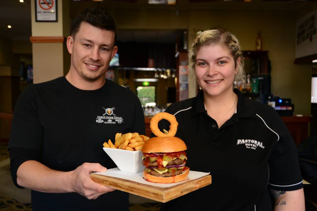 NATIONAL BURGER DAY: Pastoral licencee Chris Allan with chef Demi Jeffery with the Belly Buster burger, a big hit with Daily Liberal readers according to a recent survey. Photo: BELINDA SOOLE