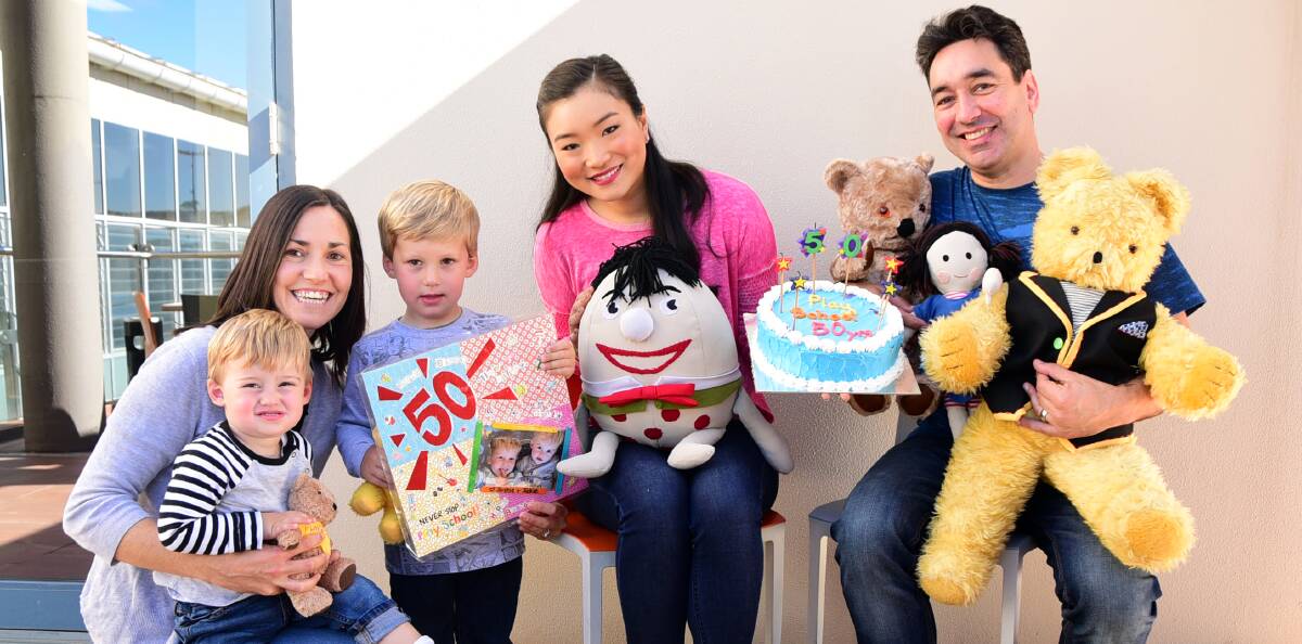 Birthday gift: Jacob, Talitha and Joshua Sawley give a card to Play School's Michelle Lim Davidson and Alex Papps. Photo: BELINDA SOOLE