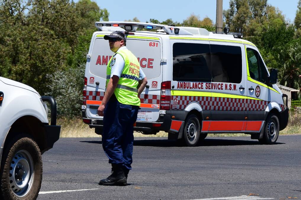 Massive task: An ambulance transports a patient from the scene to hospital on Tuesday after the crash near Dubbo. Photo: BELINDA SOOLE