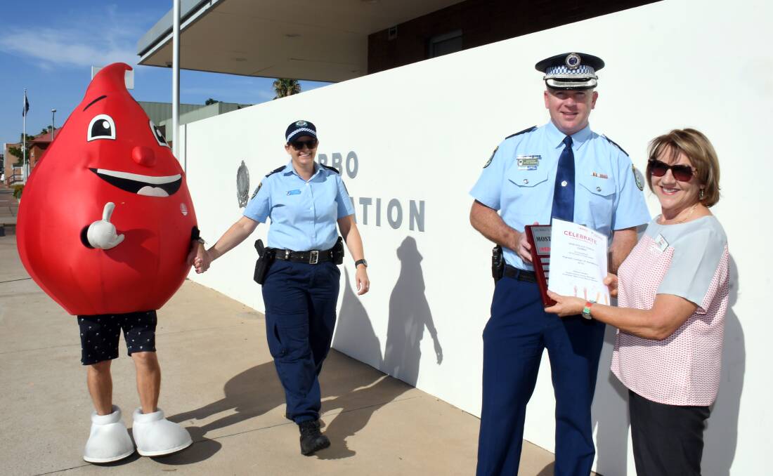 SAVING LIVES: Billy the Blood Drop, Senior Constable Jan Colbran celebrating as Superintendent Peter McKenna accepts the award from Dubbo's blood donor centre manager Debbie Garden. Photo: BELINDA SOOLE