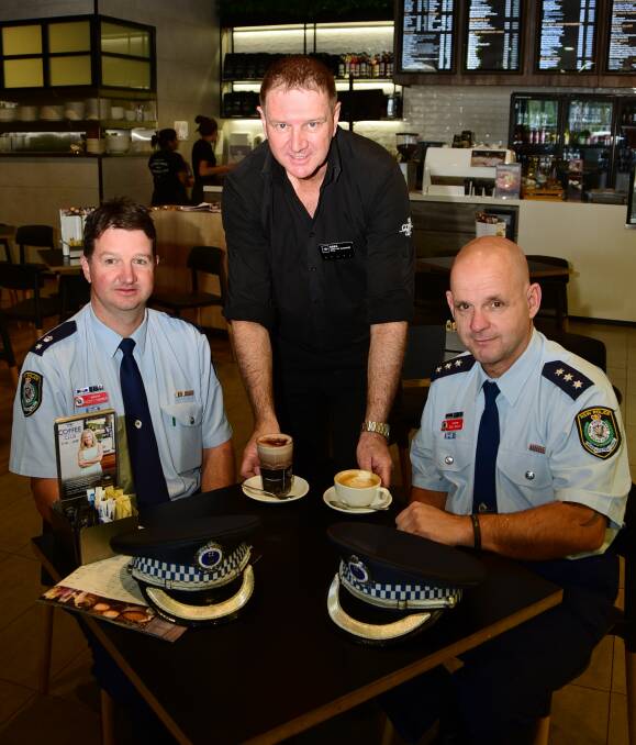 Cuppa with the cops: Acting Superintendent Scott Tanner and Inspector Dan Skelly get served their drinks by The Coffee Club's Greg Wynne. Photo: BELINDA SOOLE