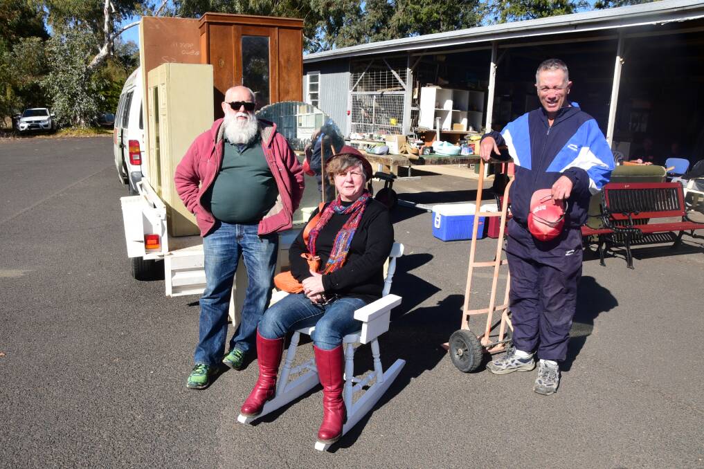 PLENTY ON OFFER: Martin and Val Clarke with Wayne Middleton at the South Dubbo Men's Shed annual Car Boot Sale. Photo: BELINDA SOOLE