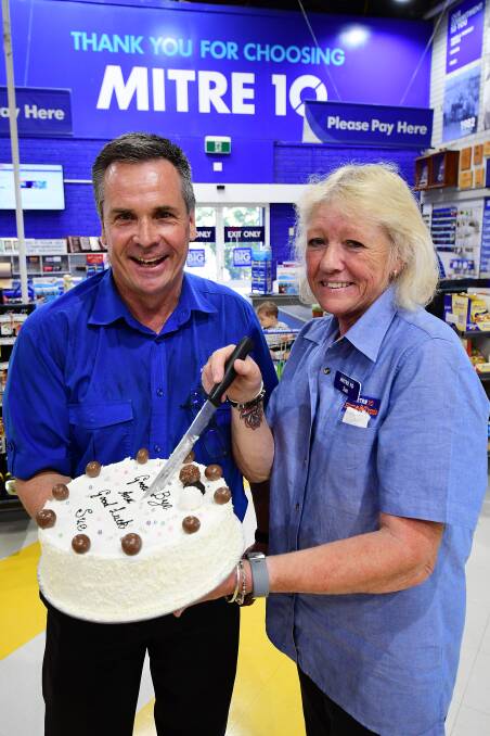 SAYING GOODBYE: Brennan's Mitre 10 owner Michael Brennan with the farewell cake for Sue Henry, who is leaving the store on Friday after 20 years of employment. Photo: BELINDA SOOLE