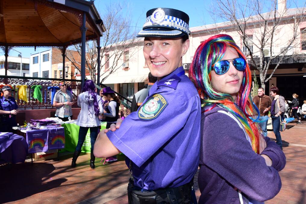 PURPLE PATCH: Inspector Gemini Bakos and headspace Dubbo's Nic Steepe take part in a Wear it Purple Day event at Dubbo's Church Street rotunda on Friday. Photo: BELINDA SOOLE