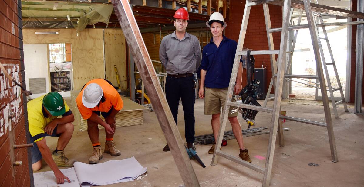 WORK UNDER WAY: Charles Sturt University's Bart Sykes and Ben Moore inspect work that will make its Dubbo campus learning commons accessible 24/7. Photo: BELINDA SOOLE