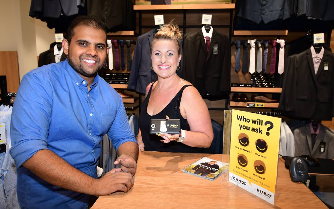 NUMBER ONE: Dubbo's Connor Clothing store is the “number one” seller of R U OK? $2 wallets among sister stores Pictured are Thomas Koratty and Terri Spears. Photo: BELINDA SOOLE