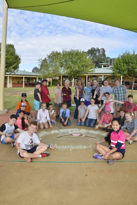 HELPING HANDS: A class (pictured) at Macquarie Anglican Grammar School has raised money for the victims of the Sir Ivan fire and through pavement art sent them a message of support. PHOTO: BELINDA SOOLE