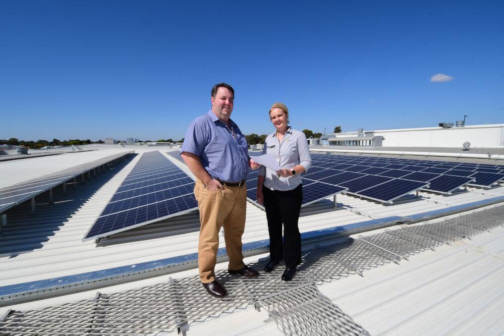 GREEN ENERGY: Bachrach Naumburger Group general manager Steve Gooley and Orana Mall centre manager Tracey Redden on top of Orana Mall with the newly installed solar panels. Photo: BELINDA SOOLE