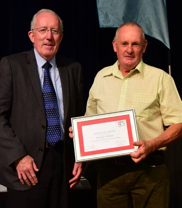 Dubbo Regional Council administrator Michael Kneipp presents an award to Michael O'Neill.