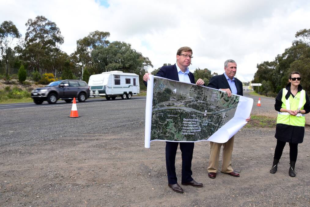 Dubbo MP Troy Grant and Roads Minister Duncan Gay with the plans for the upgraded turn off. Photo: BELINDA SOOLE