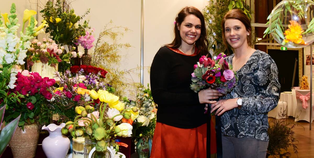 Bouquets for brides: Irissa Knight from The Meadow - Floral Design discusses blooms with the newly-engaged Emily Clow at the Dubbo Bridal and Event Expo. Photo: BELINDA SOOLE 