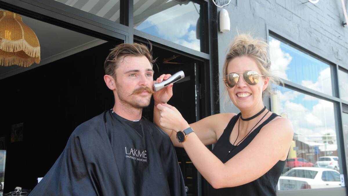 Forego the mo: Dubbo local and Black Tambourine owner Ben Cluff with hairdresser Suzy Kershaw before his moustache shave. Photo: Taylor Jurd 