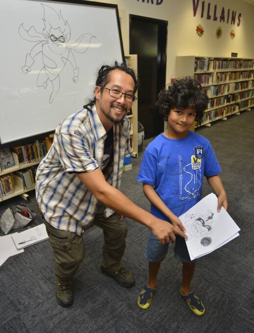 Mini artists: Illustrator and Graphic Designer Matt Lin with Zamael Berger at the Comic workshop, which was held at the Dubbo Library. Photo: Belinda Soole